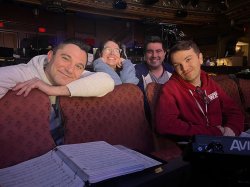 Four people, the music team for How to Dance in Ohio, sit in theater seats, smiling.