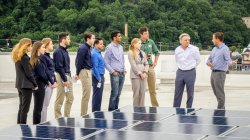 Sustainability science students with professor doing hands-on work with photovoltaic solar cells