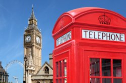 Photo of traditional red telephone box with Big Ben out of focus in the background.